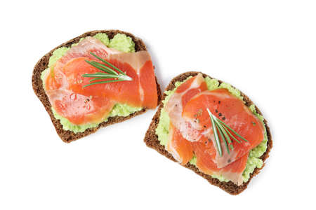 Delicious sandwiches with salmon, avocado and rosemary on white background, top viewの写真素材