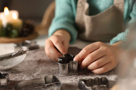 Little child making Christmas cookies at white table, closeupの写真素材