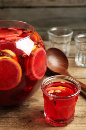 Aromatic punch drink with citrus fruits on wooden tableの写真素材