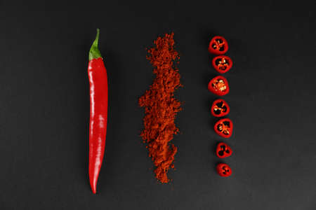 Ground red pepper and ingredient on black background, flat layの写真素材