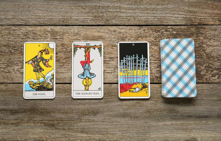 Tarot cards on wooden table, flat lay