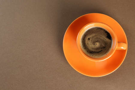 Coffee cup on brown background, top view. Space for textの写真素材