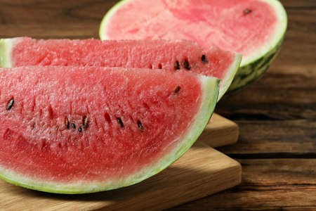 Slices of tasty ripe watermelon on wooden table, closeupの写真素材