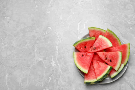 Slices of tasty ripe watermelon on light gray marble table, top viewの写真素材