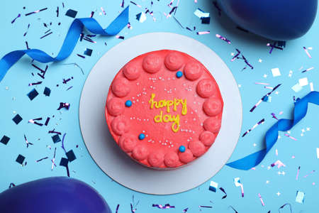 Cute bento cake with tasty cream and decor on light blue background, flat layの写真素材