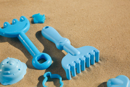 Set of plastic beach toys on sand. outdoor play