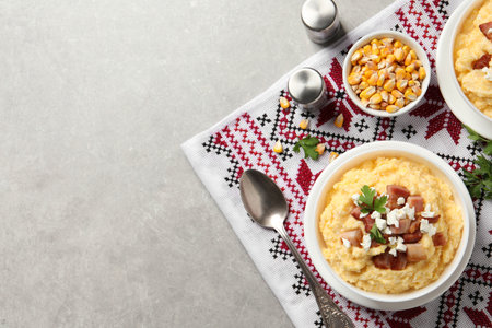 Delicious traditional Ukrainian banosh served on light gray table, flat lay. Space for textの写真素材