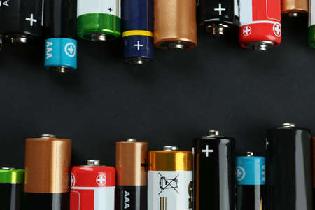 Many different batteries on black background, flat layの写真素材