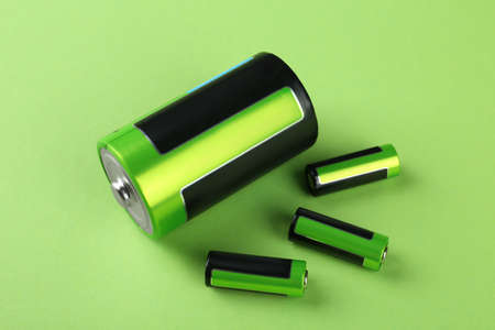 Different batteries on light green background, above viewの写真素材