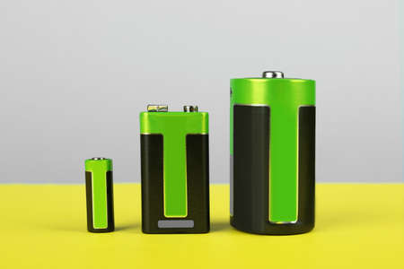 Different types of batteries on color backgroundの写真素材