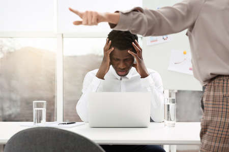African American man suffering from racial discrimination at work