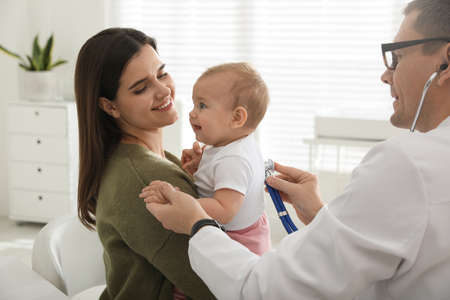 Mother with her cute baby visiting pediatrician in clinicの写真素材