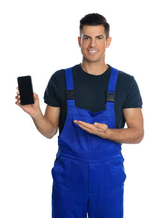 Repairman with modern smartphone on white backgroundの写真素材