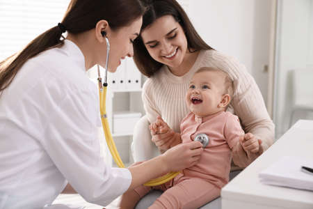 Mother with her cute baby visiting pediatrician in clinicの写真素材