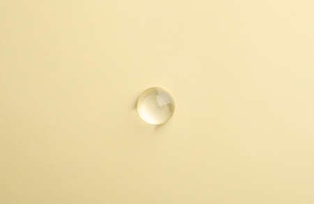 Drop of transparent ointment on beige background, top viewの写真素材