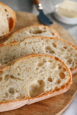Freshly baked soda water bread on wooden board, closeup