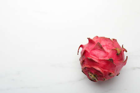 Delicious red pitahaya fruit on white marble table, top view. Space for textの写真素材