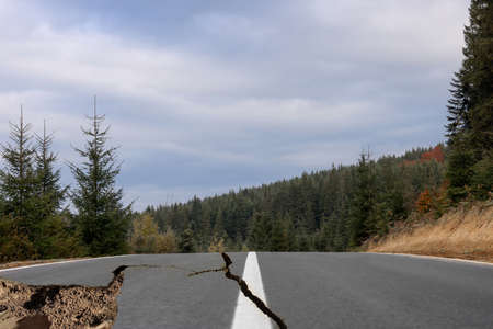 Large cracks on asphalt road after earthquakeの写真素材