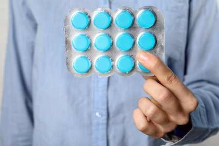 Woman holding blister with cough drops, closeupの写真素材