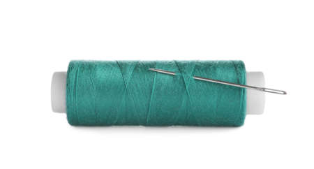 Bright sewing thread with needle isolated on white