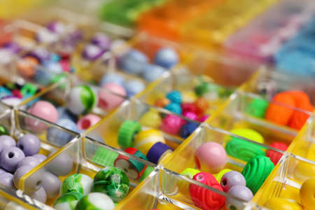 Organizer with variety of colorful beads as background, closeupの写真素材