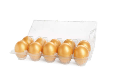 Many shiny golden eggs in plastic container on white backgroundの写真素材
