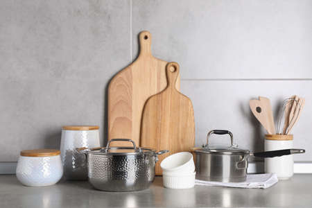 Set of different cooking utensils on gray countertop in kitchen