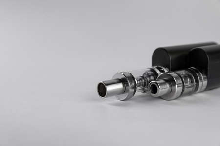 Two electronic cigarettes on light background, closeup. Space for textの写真素材