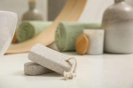 Pumice stones on white table in bathroom, space for textの写真素材