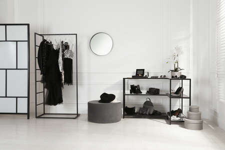 Stylish dressing room interior with trendy clothes, shoes and accessoriesの写真素材