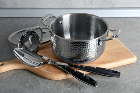 Set of different cooking utensils on gray countertop in kitchenの写真素材