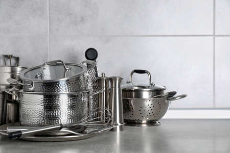 Set of different cooking utensils on gray countertop in kitchenの写真素材