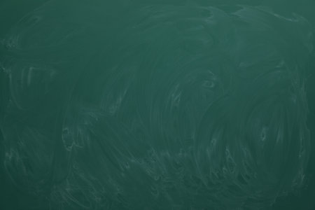 Dirty green chalkboard as background. school equipmentの写真素材