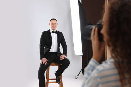 Handsome model posing for professional photographer in studio