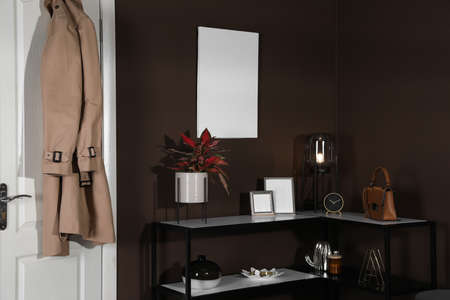 Stylish hallway interior with empty canvas on brown wall. Mockup for designの写真素材