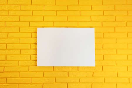 Blank canvas on yellow brick wall. space for designの写真素材