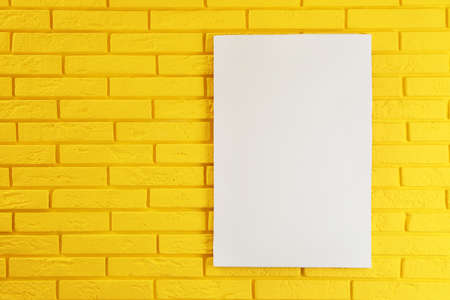 Blank canvas on yellow brick wall. space for designの写真素材