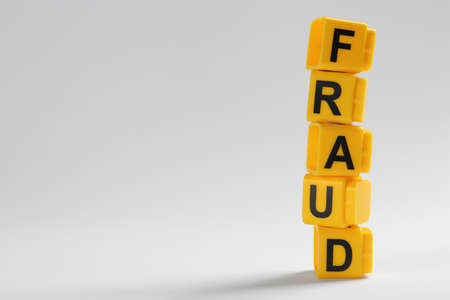 Word Fraud of yellow cubes with letters on light background. Space for textの写真素材