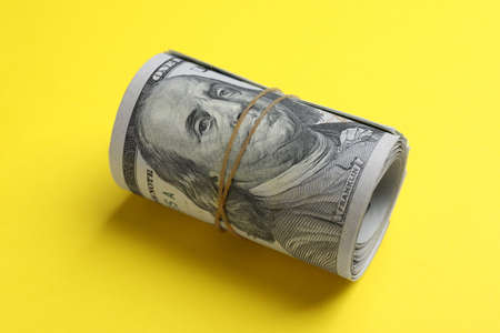 Rolled dollar banknotes on yellow background, closeup. american national currencyの写真素材