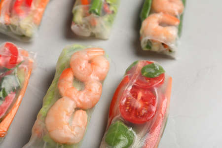 Spring rolls wrapped in rice paper on light table, closeupの写真素材