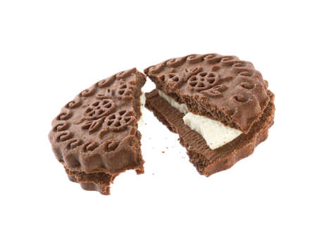 Broken tasty chocolate sandwich cookie with cream on white backgroundの写真素材