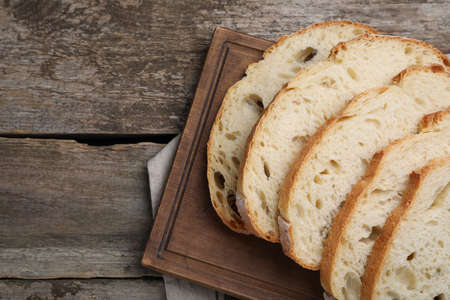 Freshly baked soda water bread on wooden table, flat lay. Space for text