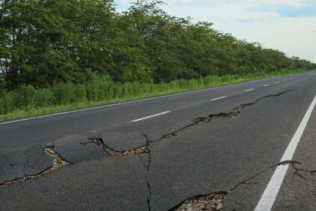 Large cracks on asphalt road after earthquakeの写真素材