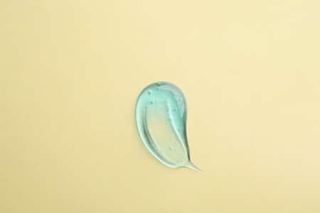 Smear of ointment on beige background, top viewの写真素材