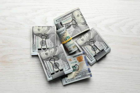 Many dollar banknotes on white wooden table, flat lay. american national currencyの写真素材