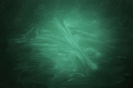 Dirty green chalkboard as background. Vignette effectの写真素材