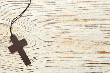 Christian cross on white wooden table, top view. Space for textの写真素材