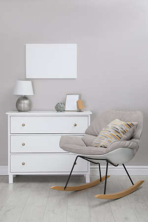 Blank canvas on wall over chest of drawers with decor in room. space for design