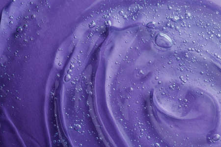 Transparent shower gel on violet background, closeupの写真素材