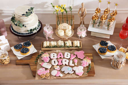 baby shower party. Different delicious treats on wooden table indoors, above viewの写真素材